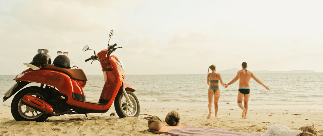 Couple on the beach in San Jose del Cabo with vespa scooter